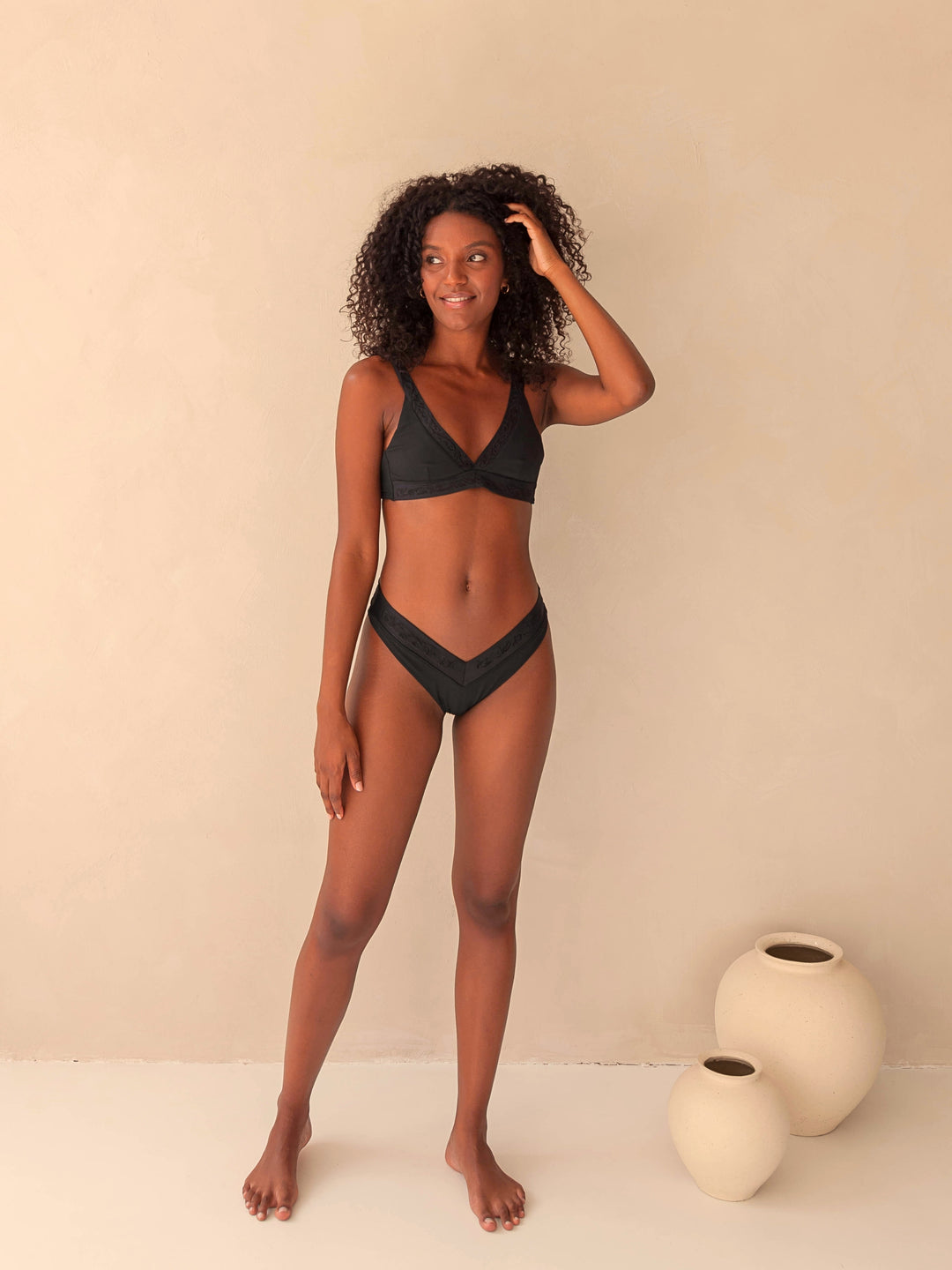 Bikini top Plunge V-neck and V-Shape bottom in black with rib fabric and embroidery, woman front